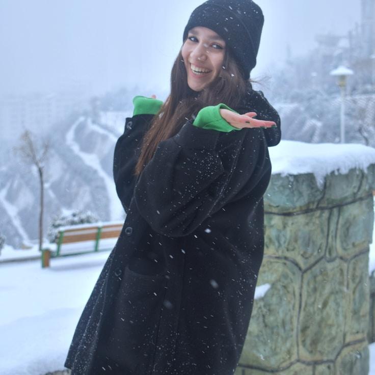 Kaveri Mehta, Lead Design Curator at LeafSparkCenter, reviewing corporate floral arrangements